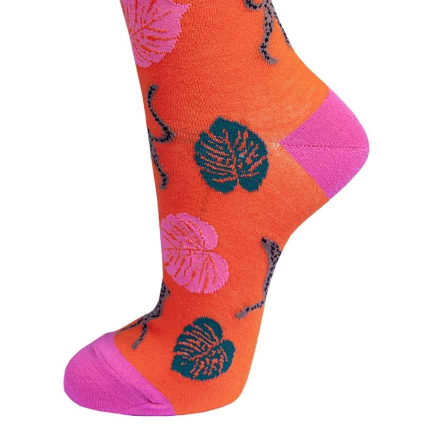 Colorful sock with leaf patterns on an orange background