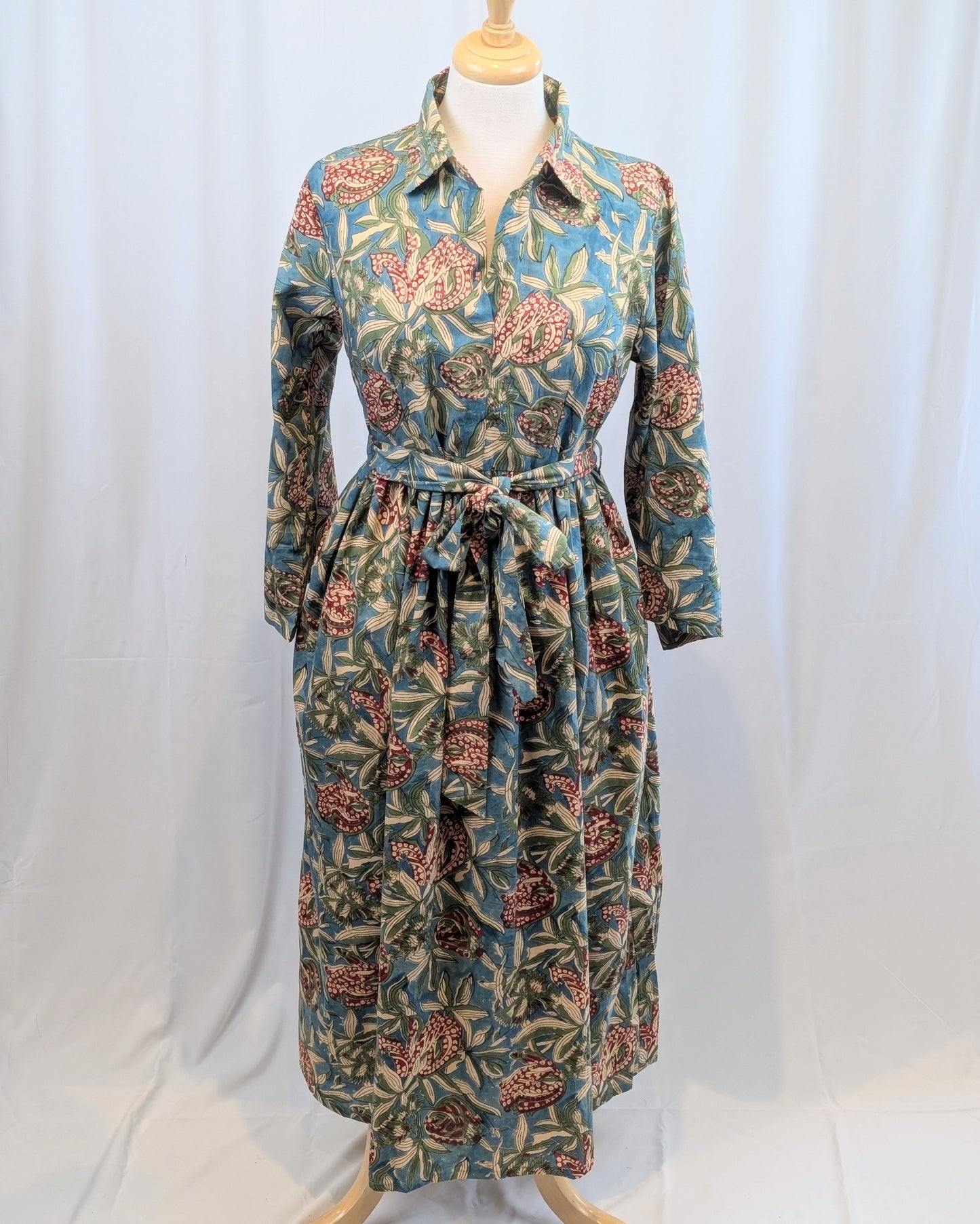 Long floral dress on a mannequin against a white background