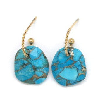 Turquoise earrings with gold hooks on a white background